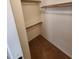 A walk-in closet with white walls, carpet, and wooden racks and shelves at 32071 N Chestnut Trl, San Tan Valley, AZ 85143