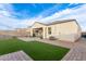 Backyard featuring artificial turf, a covered patio, and a paved area at 3530 N 310Th Dr, Buckeye, AZ 85396