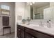 Well-lit bathroom featuring a modern vanity, sleek fixtures, and a decorative mirror at 3530 N 310Th Dr, Buckeye, AZ 85396