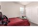A cozy bedroom featuring a comfortable bed, with a teddy bear and a window with blinds at 3530 N 310Th Dr, Buckeye, AZ 85396