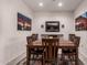 Dining area with wooden table and chairs with views of a mirror and wall art at 3530 N 310Th Dr, Buckeye, AZ 85396