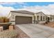 Charming single-story home featuring a two-car garage and attractive desert landscaping at 3530 N 310Th Dr, Buckeye, AZ 85396