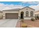 Charming single-story home featuring a two-car garage and attractive desert landscaping at 3530 N 310Th Dr, Buckeye, AZ 85396