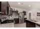 Well-lit kitchen boasts stainless steel refrigerator and granite countertops at 3530 N 310Th Dr, Buckeye, AZ 85396