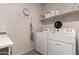 Functional laundry area featuring a washer, a dryer, a shelf and wall decorations at 3530 N 310Th Dr, Buckeye, AZ 85396