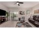 Inviting living room featuring neutral walls, tile flooring, and modern ceiling fan at 3530 N 310Th Dr, Buckeye, AZ 85396