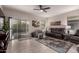 Inviting living room featuring neutral walls, tile flooring, and access to the backyard at 3530 N 310Th Dr, Buckeye, AZ 85396