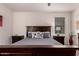 Well-lit bedroom showcasing a dark wood bed frame with 2 bedside tables at 3530 N 310Th Dr, Buckeye, AZ 85396