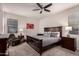 Cozy bedroom featuring a ceiling fan, and two bedside tables with lamps at 3530 N 310Th Dr, Buckeye, AZ 85396