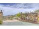 Custom rustic entrance gate with desert themed design, adding charm and privacy to the property at 36879 N 38Th St, Cave Creek, AZ 85331