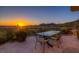 Outdoor dining area with patio furniture, cacti and mountain views at sunset at 36879 N 38Th St, Cave Creek, AZ 85331