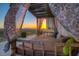 Relaxing outdoor lounge area featuring bamboo accents, sheer curtains, and scenic mountain views at 36879 N 38Th St, Cave Creek, AZ 85331