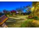 Backyard putting green with lush landscaping and lounge chairs for relaxation at 36879 N 38Th St, Cave Creek, AZ 85331