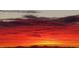 Dramatic sunset with layers of red and orange clouds over silhouetted mountains at 36879 N 38Th St, Cave Creek, AZ 85331