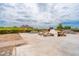 Unfinished backyard renovation showing patio layout with piles of materials, and mountain views at 3933 E Rancho Dr, Paradise Valley, AZ 85253