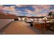 Inviting backyard with a wooden swing, shaded seating, and desert-style landscaping at 3933 E Rancho Dr, Paradise Valley, AZ 85253