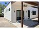 Modern home exterior featuring a covered patio with ceiling fan, and clean architectural lines at 3933 E Rancho Dr, Paradise Valley, AZ 85253