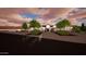 Inviting home with a manicured front yard and mature landscaping, enhanced by evening lighting at 3933 E Rancho Dr, Paradise Valley, AZ 85253
