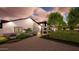 Attractive home with well-maintained landscaping and a covered patio, enhanced by soft evening lights at 3933 E Rancho Dr, Paradise Valley, AZ 85253
