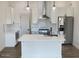 A bright kitchen features stainless steel appliances, white cabinets and island at 3933 E Rancho Dr, Paradise Valley, AZ 85253