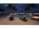Night view of the pool with lounge chairs, palm trees and mood lighting for evening swims at 3933 E Rancho Dr, Paradise Valley, AZ 85253