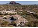 An aerial view showing the home, its backyard pool, and the desert landscape at 3977 E Paradise View Dr, Paradise Valley, AZ 85253