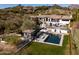 An aerial view showcasing the expansive backyard with a pool, spa, and desert landscaping at 3977 E Paradise View Dr, Paradise Valley, AZ 85253