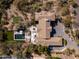An aerial view of a private backyard with a pool, patio, and putting green at 3977 E Paradise View Dr, Paradise Valley, AZ 85253