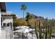 Inviting balcony featuring mountain views, desert landscaping, and comfortable outdoor seating at 3977 E Paradise View Dr, Paradise Valley, AZ 85253