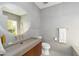 Modern bathroom with a round mirror over a stylish concrete sink and a walk in shower at 3977 E Paradise View Dr, Paradise Valley, AZ 85253