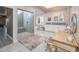 Spacious bathroom featuring a glass enclosed shower, vanity, and soaking tub near a bright window at 3977 E Paradise View Dr, Paradise Valley, AZ 85253