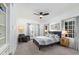 Bedroom with a bed, ceiling fan, bedside tables, and a chair with natural light at 3977 E Paradise View Dr, Paradise Valley, AZ 85253