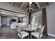 Open dining and living area with modern table, chairs, hardwood floors, and natural lighting at 3977 E Paradise View Dr, Paradise Valley, AZ 85253