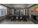 Formal dining room with a modern chandelier, long table, and dark accents for an elegant atmosphere at 3977 E Paradise View Dr, Paradise Valley, AZ 85253
