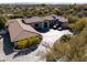 Expansive single story home featuring a well-manicured front yard and a circular driveway at 3977 E Paradise View Dr, Paradise Valley, AZ 85253