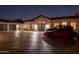 Stunning exterior view of the home showcasing a red sports car in the driveway at 3977 E Paradise View Dr, Paradise Valley, AZ 85253