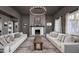 Elegant living room featuring neutral color palette, fireplace, stylish lighting, and comfortable seating at 3977 E Paradise View Dr, Paradise Valley, AZ 85253