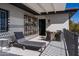 Outdoor patio area featuring lounge seating and a dining table with a sunshade at 3977 E Paradise View Dr, Paradise Valley, AZ 85253