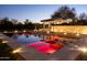 Tranquil pool with ambient lighting, lounge chairs, and serene landscaping in backyard at 3977 E Paradise View Dr, Paradise Valley, AZ 85253