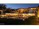 Inviting pool area with modern lounge chairs, umbrellas, and elegant outdoor lighting at twilight at 3977 E Paradise View Dr, Paradise Valley, AZ 85253
