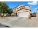 Charming two-story home features a well-maintained lawn, a two car garage, and covered entry at 43542 W Oster Dr, Maricopa, AZ 85138