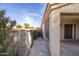 Enclosed backyard with concrete patio, block wall, partial shade screen and desert landscaping at 43639 W Blazen Trl, Maricopa, AZ 85138