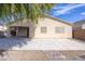 Rear exterior view of the home showing an extended covered patio and desert-style landscaping at 43639 W Blazen Trl, Maricopa, AZ 85138