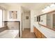 Large bathroom with tub, double vanity, and tiled floors at 43639 W Blazen Trl, Maricopa, AZ 85138