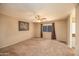 This bedroom offers a neutral palette with carpet, ceiling fan, and a window at 43639 W Blazen Trl, Maricopa, AZ 85138