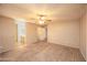 Large bedroom with carpet, ceiling fan and a view to an en-suite bathroom at 43639 W Blazen Trl, Maricopa, AZ 85138