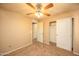 Spacious bedroom with closet, ceiling fan, carpet, and neutral walls at 43639 W Blazen Trl, Maricopa, AZ 85138