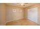 Cozy bedroom with neutral walls, tile flooring, and double door closet for ample storage at 43639 W Blazen Trl, Maricopa, AZ 85138
