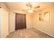 Bedroom with ceiling fan, carpet, and closet at 43639 W Blazen Trl, Maricopa, AZ 85138