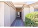 Covered entryway with brick accents and a view of the front door at 43639 W Blazen Trl, Maricopa, AZ 85138